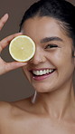 Lemon, studio and face of woman for skincare, facial detox and anti aging on brown background. Dermatology, beauty and portrait of person with citrus fruit for vitamin c, natural glow and hydration