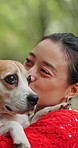 Kiss, face and dog with woman in park for bonding, pet training and foster care. Animal adoption, happiness and love with person and beagle in nature for relax, summer holiday and canine friend