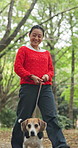 Happy, nature and woman with walking dog for pet care, exercise or morning activity in forest. Smile, leash and Japanese female person with beagle puppy for outdoor health, wellness or adventure.