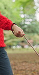 Walk, leash or hands of person with pet at park for outdoor adventure, companion and bonding. Dog, relax or travel in nature with rope, puppy and animal for fresh air, exercise and peace in woods