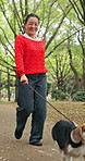 Happy, nature and woman running with dog for pet care, exercise or morning activity in forest. Smile, leash and Japanese female person with beagle puppy for outdoor health, wellness or adventure.