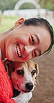 Smile, face and dog with woman in park for bonding, pet training and foster care. Animal adoption, happiness and love with person and beagle in nature for relax, summer holiday and canine friend