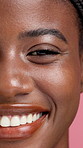 Black woman, face and beauty with smile in studio for makeup or cosmetics on a pink background. Portrait, female person or happy model with teeth in closeup for skin cosmetology, skincare or glow up