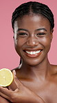 Face, skincare and woman with lemon for beauty, natural wellness and happy. Portrait, cosmetics and African model with fruit for vitamin c, organic benefits and detox on pink studio background
