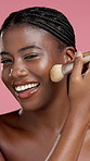 Face, beauty and black woman with makeup brush in studio for foundation, powder application and glow. Self care, cosmetics tools and skincare with happy model with facial product on pink background
