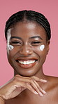Cream, happy and face of African woman for skincare, facial cosmetics and anti aging in studio. Dermatology, pink background and portrait of person with lotion for moisturizer, hydration and beauty