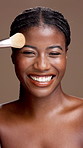 Face, apply or happy black woman with brush for skincare, beauty or facial makeup. Satisfaction, smile or African model with cosmetics for even tone, foundation and treatment by studio background