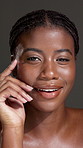 Skincare, smile and hand with face of black woman in studio for beauty, shine and dermatology. Glow, collagen and hydration with female person on dark background for self care and clear skin