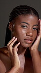 Skincare, shine and hand with face of black woman in studio for beauty, pride and dermatology. Glow, collagen and hydration with female person on dark background for self care and clear skin