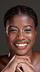 Skincare, happy and hand with face of black woman in studio for beauty, shine and dermatology. Glow, collagen and hydration with female person on dark background for self care and clear skin