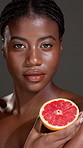 Skincare, face and black woman in studio with grapefruit for natural, organic or glow routine. Health, portrait and African person with citrus fruit for brightening dermatology by gray background.