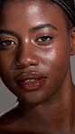 Face, African woman and skincare in studio of natural beauty, smooth texture and glow results. Female person, lighting and cosmetics of facial, treatment aesthetics and dermatology on gray background