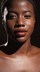 Face, African woman and beauty in studio of natural skincare, smooth texture and glow results. Female person, lighting and facial cosmetics, treatment aesthetics and dermatology on dark background