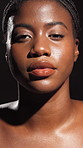 Face, African woman and skincare of natural beauty, smooth texture and glow results in studio. Female person, lighting and cosmetics of facial, treatment aesthetics and dermatology on dark background