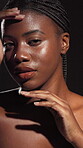 Skincare, natural and face of African woman in studio for natural beauty, cosmetics and body care. Shadow, portrait and person with glow for dermatology, self care and hydration on dark background