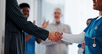 Business person, shaking hands and nurse for congratulations, healthcare funding and applause in clinic. Hospital director, handshake and team for NGO deal, agreement and partnership celebration