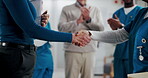 Business person, handshake and nurse in clinic for medical support, healthcare funding and applause. Hospital director, shaking hands and team for NGO deal, agreement and partnership celebration