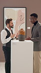 Art, conversation or museum tour with guide and man in gallery for experience or information. Collection, display or vase with curator and customer speaking at exhibition for culture or history