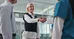 Woman, doctors and handshake with team at hospital with welcome, onboarding or happy in corridor. People, medical director and shaking hands with promotion, recruitment or hiring with group at clinic