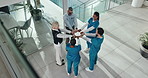 People, fist bump and team of doctors at hospital, circle or above with solidarity for medical career. Group, nurses or surgeon in huddle with support, collaboration or community at healthcare clinic