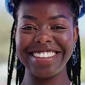 Face, engineering and black woman in city, smile and urban development ...