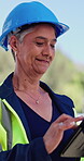 Woman, engineer and smile with tablet at construction site with typing, notes and safety report. Mature person, architect and tech with app, inspection and property development project in Mexico