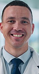 Face, doctor and happy man in hospital for healthcare service, wellness or about us. Portrait, medical professional and smile with general practitioner, surgeon and confident employee in Spain