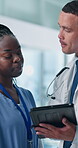 Doctor, nurse and tablet with discussion, team and feedback with medical research at hospital. Healthcare professional, man and woman with app, report or review with advice for solution at clinic