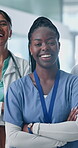 Doctors, team and arms crossed with face, smile and pride for medical career in hospital corridor. Healthcare professional, women and man with group, solidarity or portrait for services at clinic