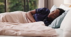 Black woman, sleeping and rest in bed, tired or home for comfort, dreaming or recovery. African person, exhausted and fatigue in bedroom with blanket in pajamas for nap, relax or wellness at house
