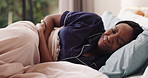Black woman, bed and stomach pain in home with menstruation, abdomen cramps or frustrated in morning. African person, belly ache or inflammation with indigestion, bloating or sick in bedroom at house