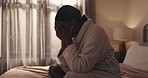 Sad, black woman and crying on bed for breakup, bad news or mental breakdown in home. Female person, emotional or disbelief with grief, divorce or loss in bedroom for depression, anxiety or sadness