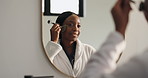 Mirror, bathroom and black woman with gua sha for skincare, beauty and facial treatment in home. Morning routine, reflection and person with jade roller for anti aging, smooth skin and self care