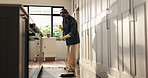Broom, sweeping and black woman in home for cleaning, floor maintenance and hygiene in kitchen. Housework, apartment and person with dirt for housekeeping, dust prevention and prevention for chores