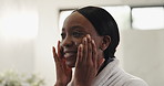 Happy, black woman and skincare with lotion in bathroom for facial moisturizer or cosmetics in home. Face, female person or smile with beauty cream for anti aging, treatment or soft skin in house