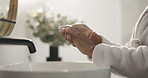 Person, hands and cosmetics with sink in bathroom for skincare, hygiene or moisturizer in home. Closeup, user or robe with product or health and wellness for cleaning, wash or treatment in house