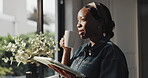 Thinking, woman and coffee in kitchen, tablet or smile for remote work, laugh and writer with story. Drinking, tea and black person with tech for ebook, freelance or happy with finished novel in home