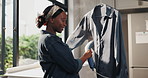 Black woman, smile and steaming shirt in home for material care, chores and remove allergens. Person, blouse and appliance in living room for outfit refreshing, eliminate wrinkles and cleaning