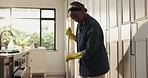 Broom, sweep and black woman in home for cleaning, floor maintenance and hygiene in kitchen. Housework, apartment and person with dirt for housekeeping, dust removal and prevention for chores