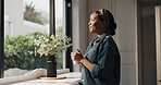 Daydreaming, woman and coffee in morning, home or smile with hot beverage in kitchen, happy or calm. Reflection, peace and black person with caffeine in house, relax and break on weekend or memory
