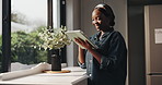 Tablet, home and happy black woman on internet for flower shopping, decor and reading email. Smile, digital technology and person in house for floral purchase, search or browsing website by window