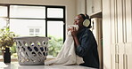 Smelling, fragrance and woman with chores, home or spring cleaning on weekend, laundry and material. Fresh, scent and black person with headphones in house, housework and hygiene for fabric and cloth