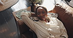 Black woman, thinking and relax on sofa with smile, comfort and stress free in living room. Above, female person and reflection in home with good mood, day dreaming and peace with satisfaction