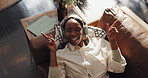 Headphones, happy and above of black woman on sofa for streaming subscription, track and playlist. Home, relax and person on couch for listening to music, radio and audio in living room on weekend