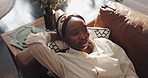 Black woman, thinking and happy on sofa for relax, comfort and stress free in living room. Above, female person and reflection in home with good mood, day dreaming and peace with satisfaction