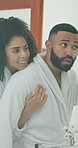 Couple, hug and mirror with lotion for skincare, beauty cosmetics and facial treatment in bathroom. People, embrace and cream of sunscreen protection, apply moisturizer and collagen benefits at house