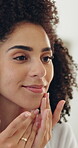 Woman, mirror and touch for skincare in bathroom, beauty glow and cosmetics of facial treatment. Female person, reflection and wink for healthy skin, self care shine and dermatology benefits at house