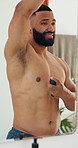 Happy man, spray and armpit with mirror or deodorant for hygiene, cosmetics or fragrance in home. Male person, smile and fresh smell with body mist or reflection for clean perfume or cologne in house