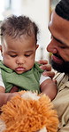 Happy, toy and parents with baby in home for bonding, development and playful relationship. Family, house and cute child, mom and dad with care for affection, growth and love in living room together