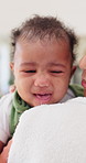 Woman, comfort baby and crying in home with cloth, support and love for morning routine. Mother, infant child and blanket in bedroom with embrace, tired or fatigue with single parent at family house